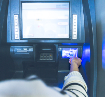 person inserting card in an ATM