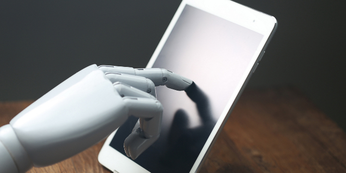 robotic hand touching a tablet
