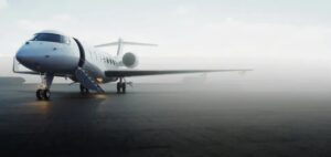 Private jet parked on a foggy airport runway.