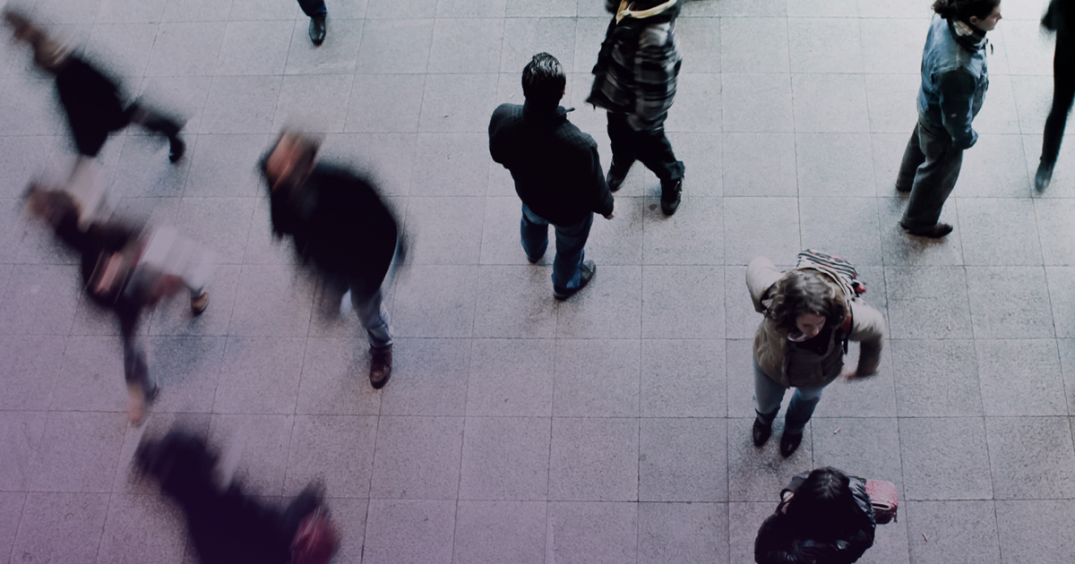 Overhead view of pedestrians crossing a street.