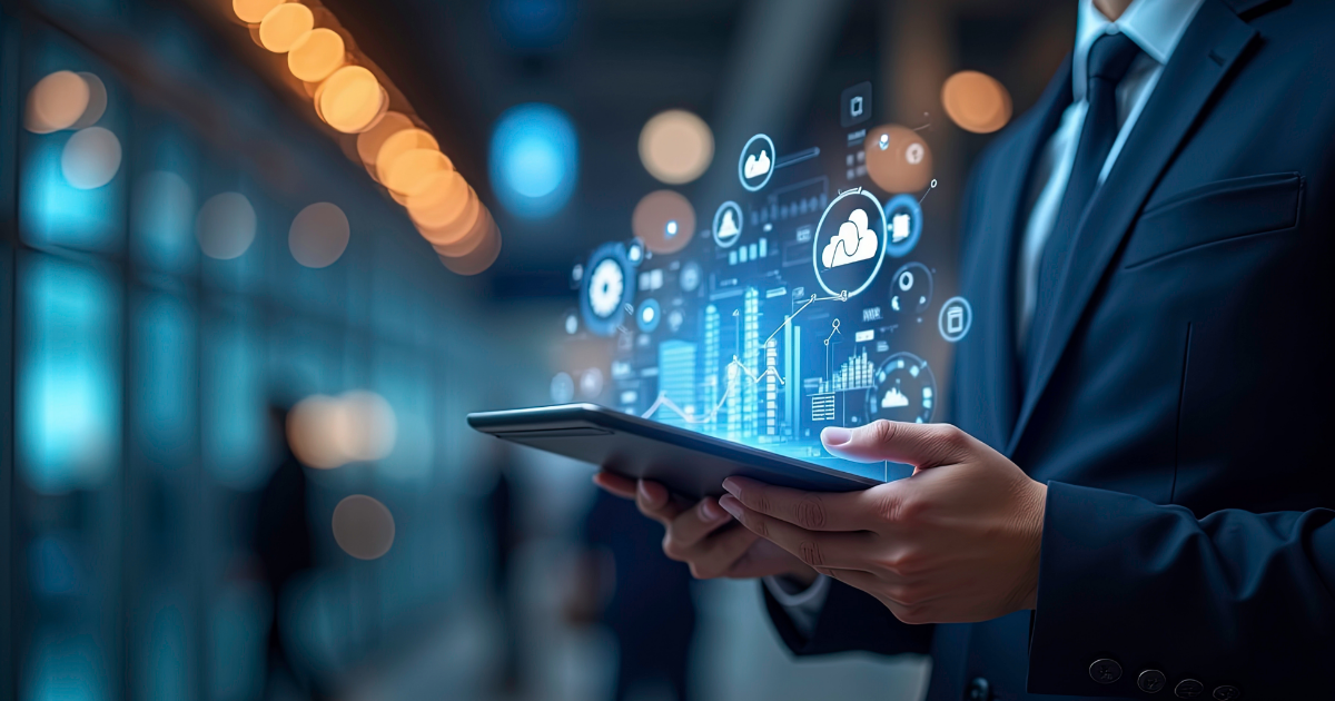 Businessman holding a tablet projecting cloud, chart, and data icons, representing the evolution from data lakes to data fabrics.