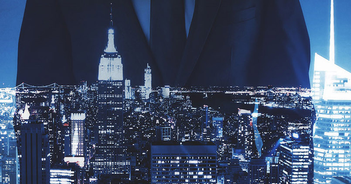 Night skyline of New York City framed by two people in suits.