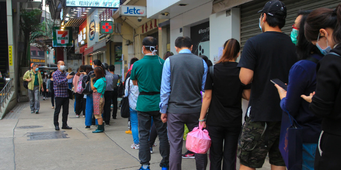 people lining up on the sidewalk
