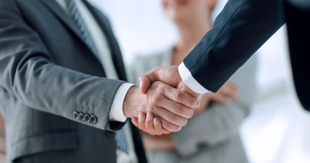 Two business people shaking hands.