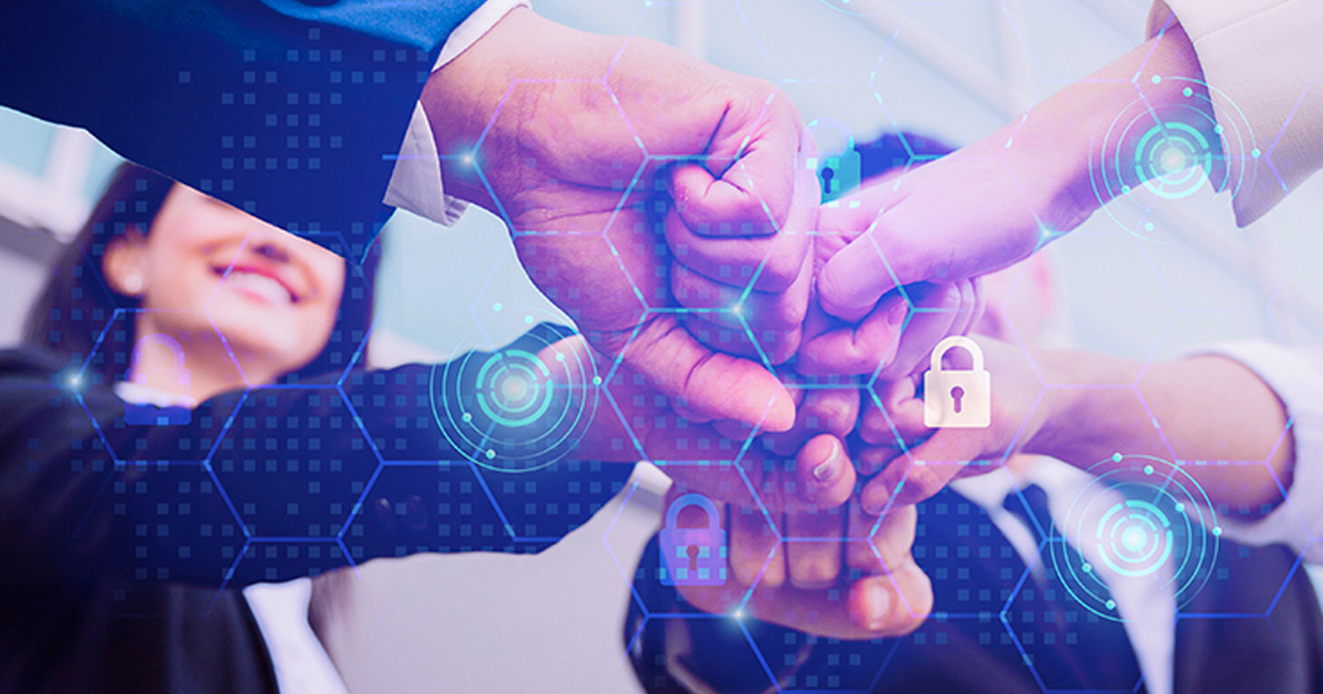 Team stacking hands together overlaid with digital security icons.
