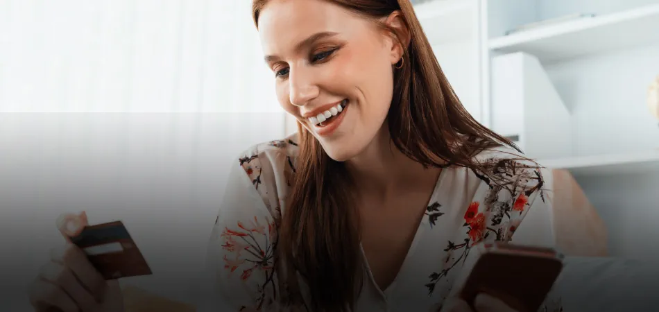 Woman using a smartphone and credit card to shop online